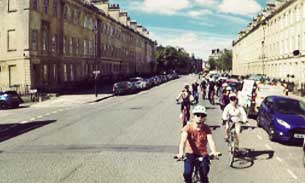 People cycling on road in Bath, England.