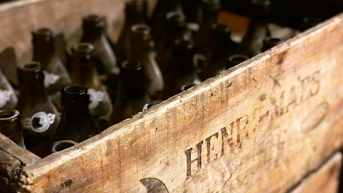 Belgium beer bottles in an antique crate.