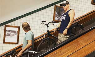 People using bicycle escalator in Antwerp, Belgium.