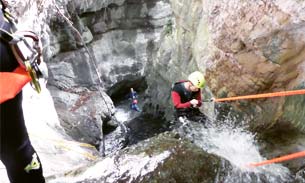 Person abseiling down a waterfall in Lake Garda