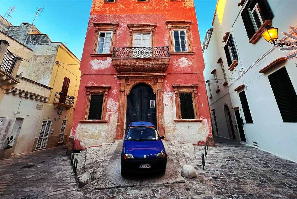 Fiat car parked in a colourful Italian town