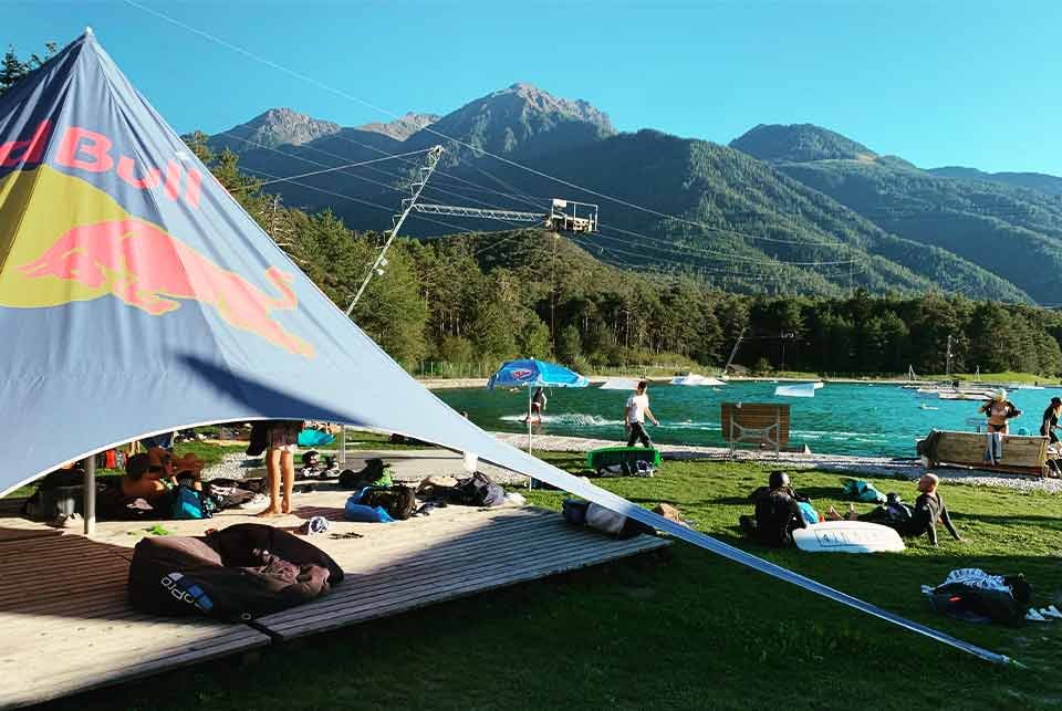 Sun shade relaxation area next to an alpine lake