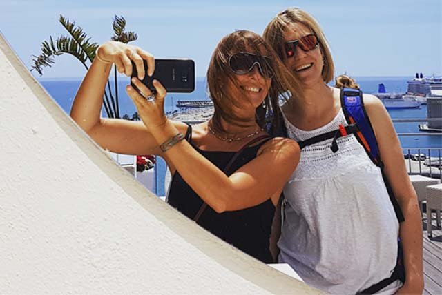 2 people taing a selfie on a rooftop