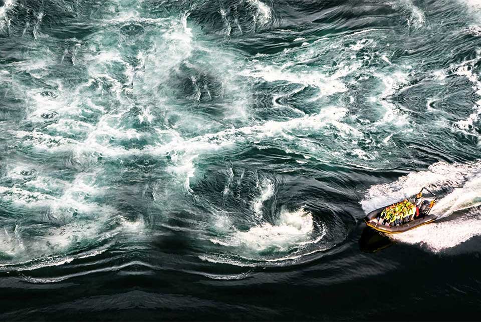 Rib boat riding through whirlpools
