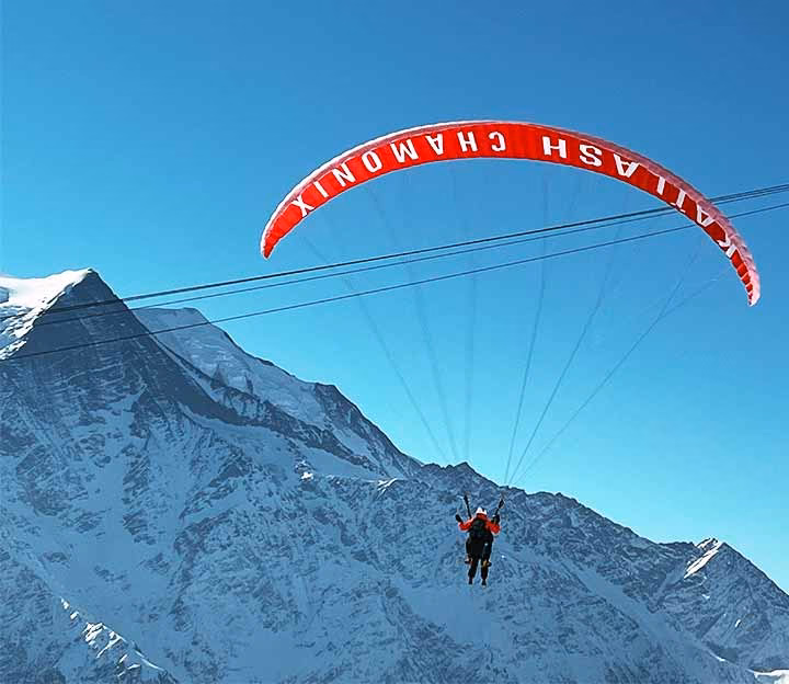 Person paragliding in the mountains above Chamonix