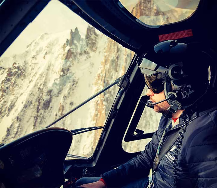 Helicopter pilot flying through the mountains above Chamonix