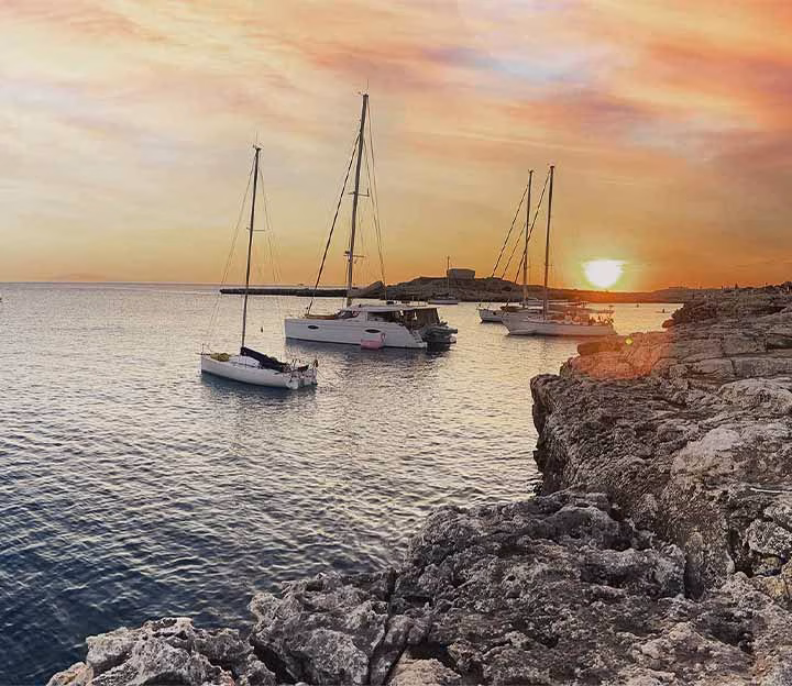 Yachts moored at sunset in a Menorcan cove