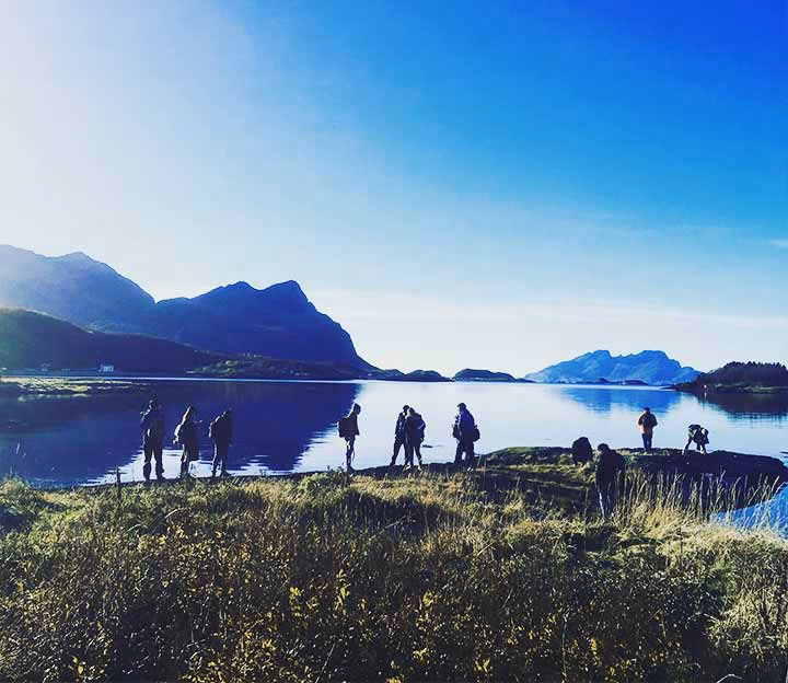 People standing on a ridge on the coast of Norway