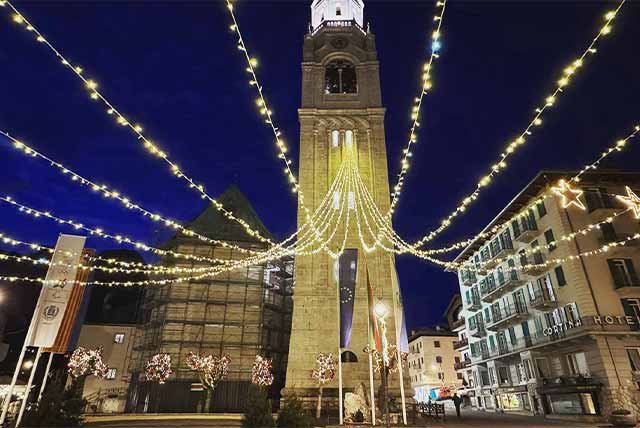 Light hanging across a church square in the Italian Alps