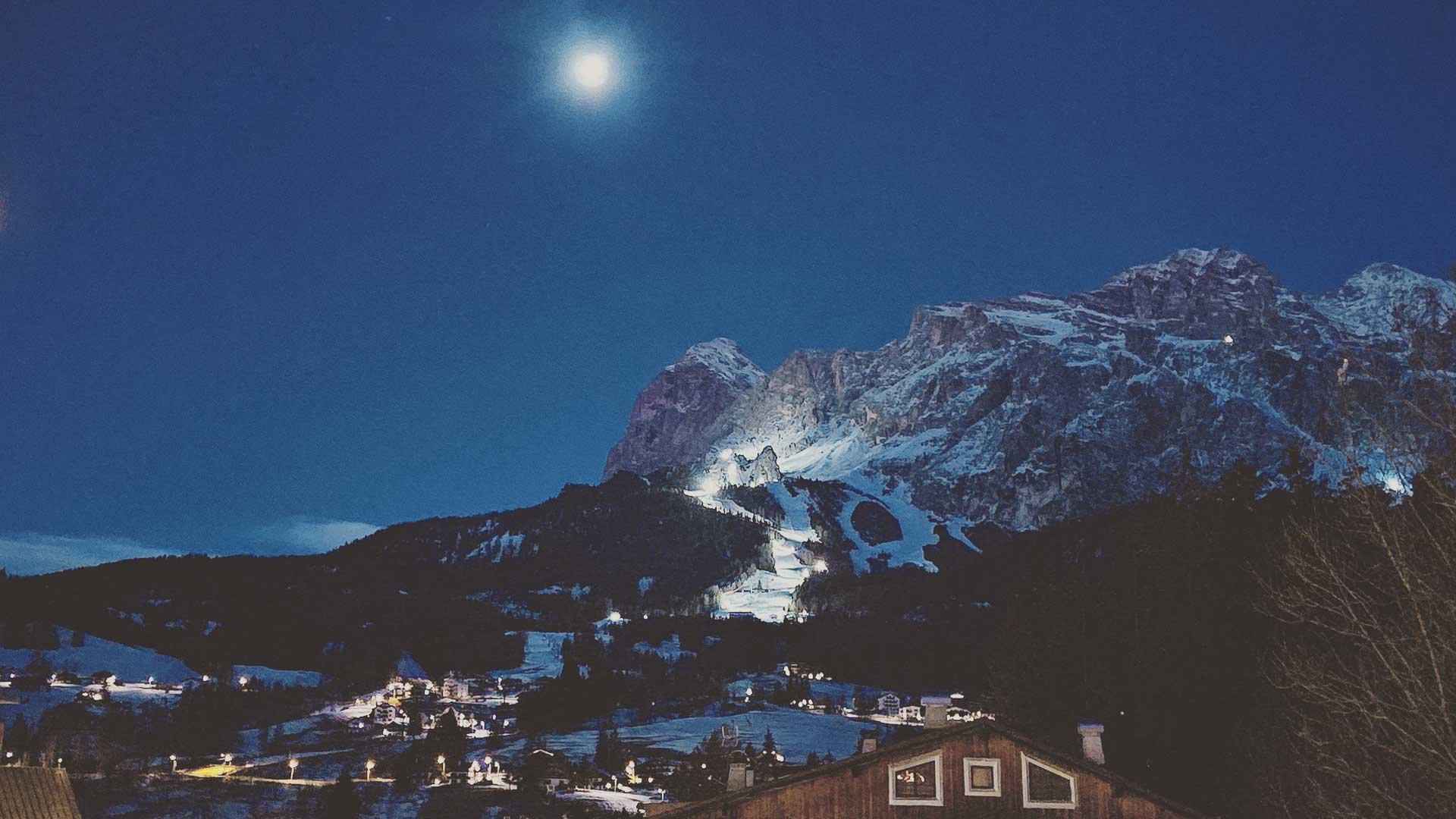 Dolomite mountains lit by the moon and floodlights