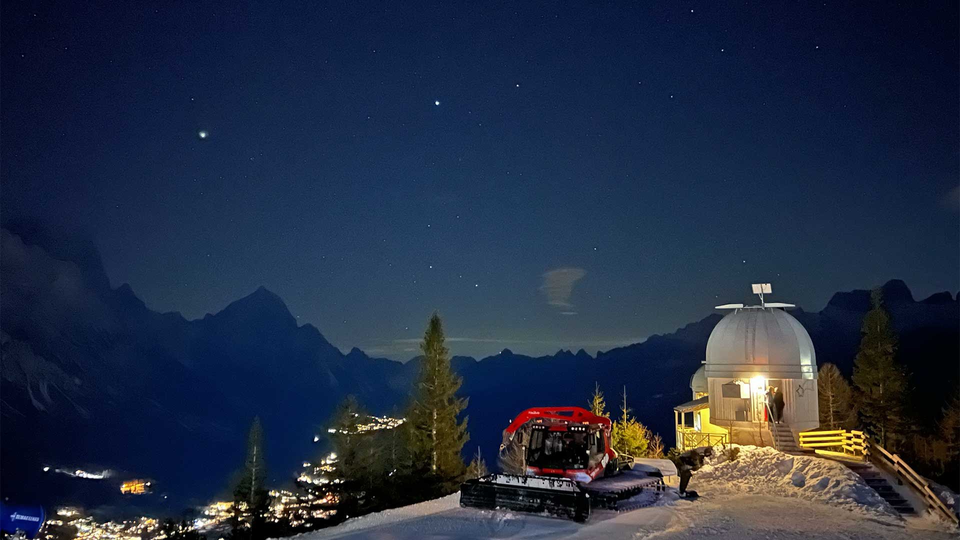 Observatory on a mountain peak at night
