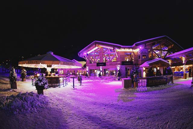 Illuminated hotels in the snow at night