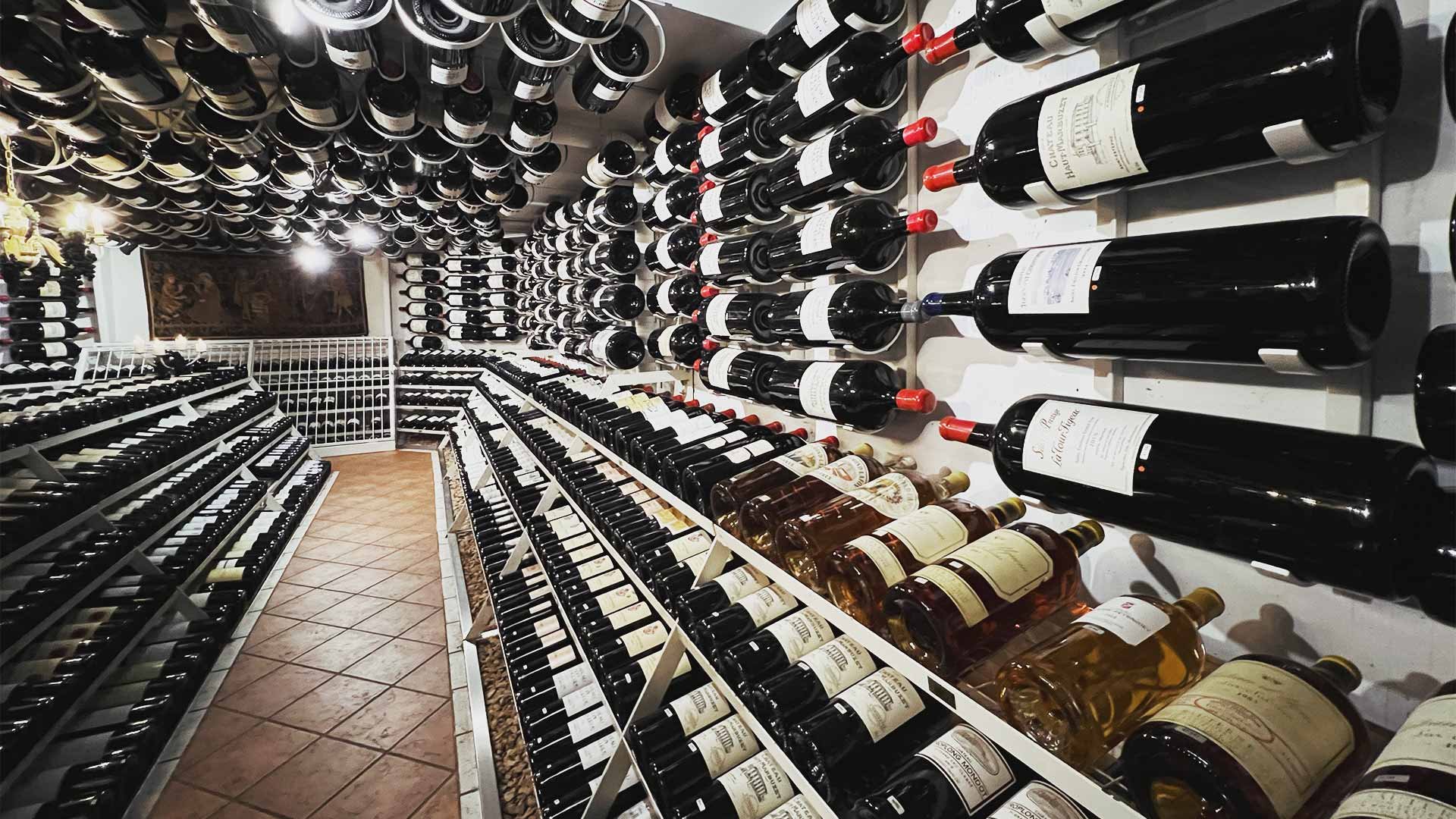 Wine bottles on the wall and ceiling of a wine cellar