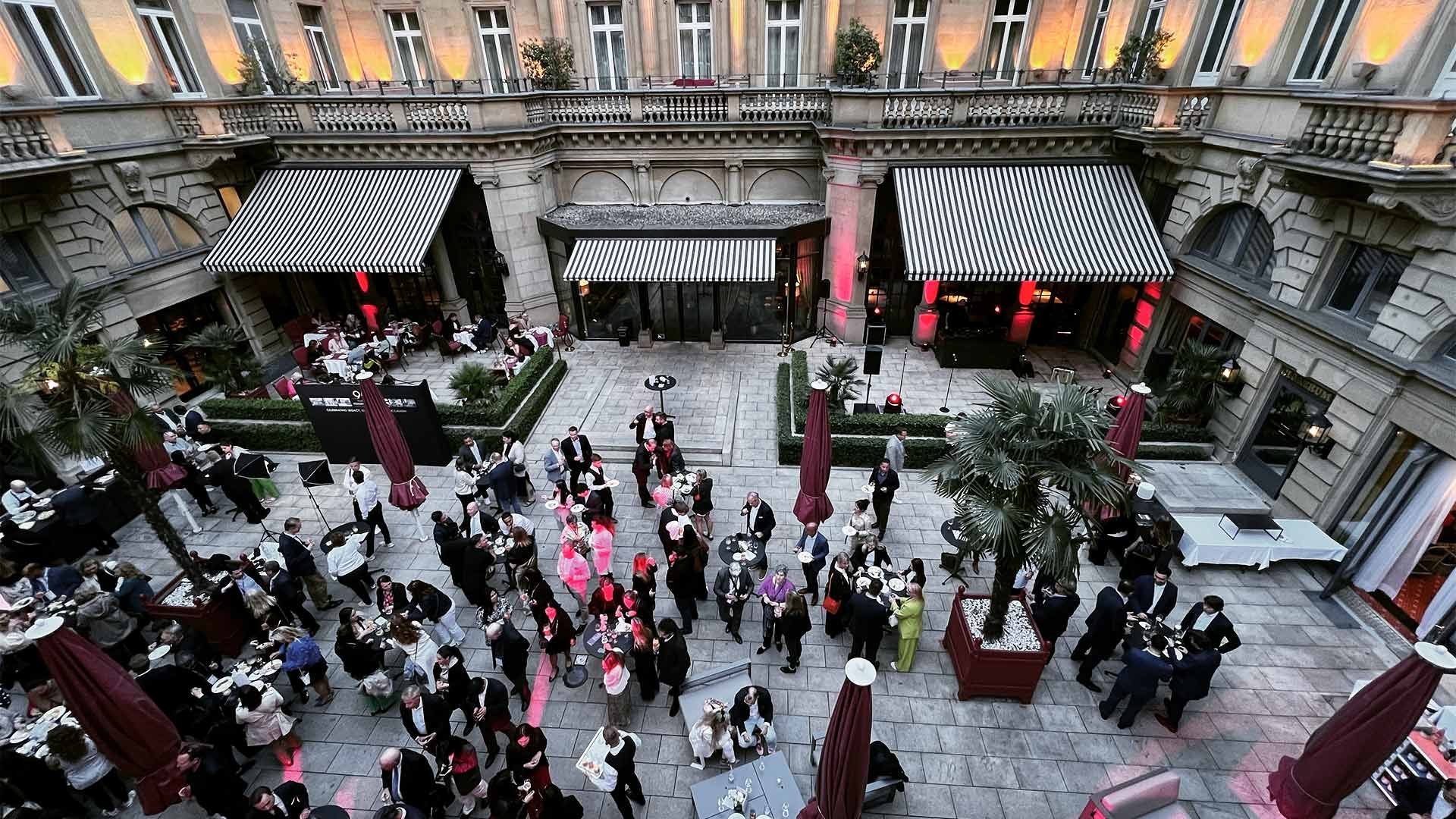 View over a cocktail party on a hotel courtyard