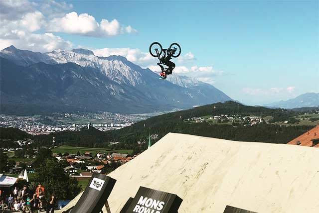 A mountain biker performing a flip
