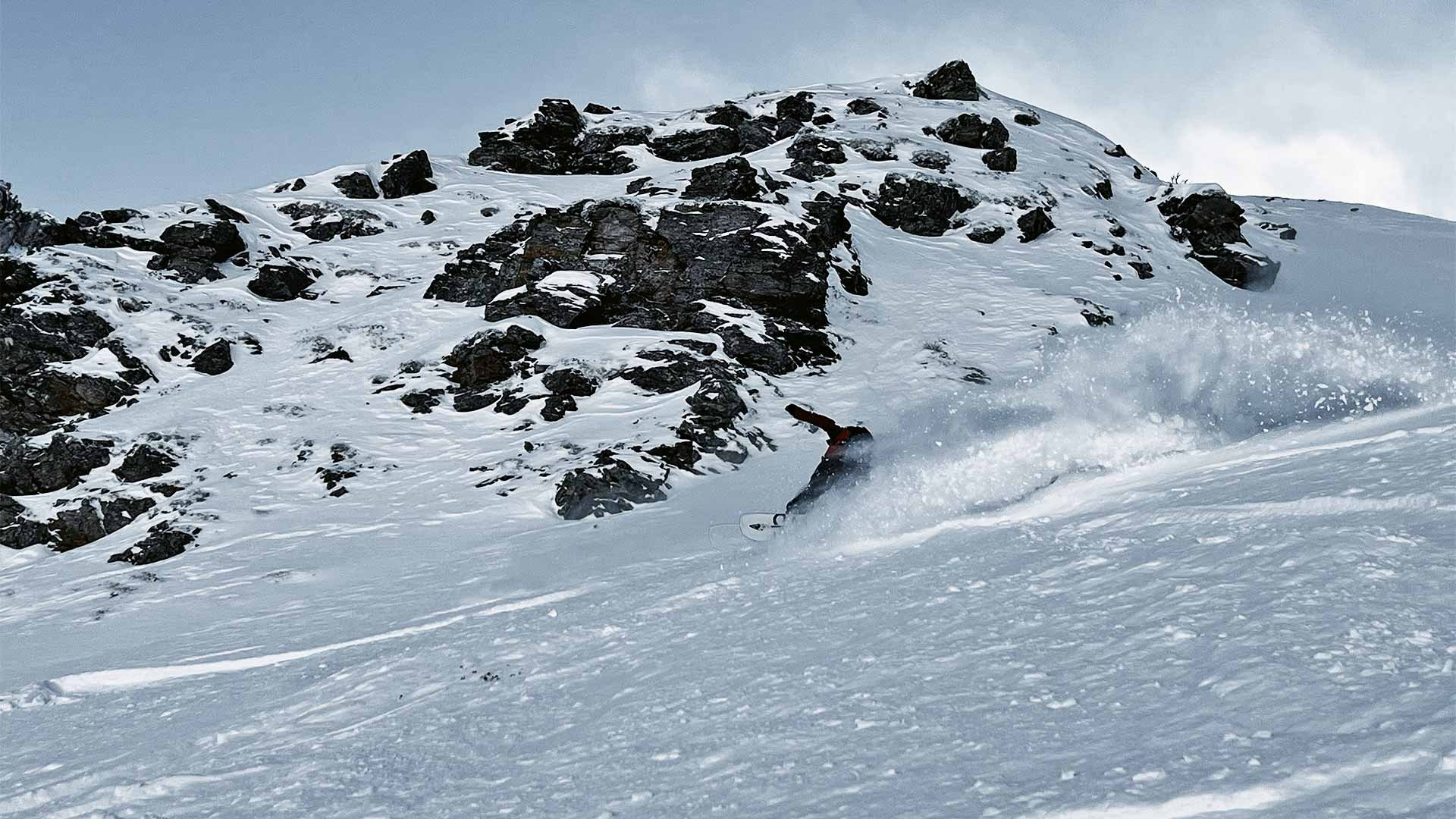 Snowboarder turning in powder snow