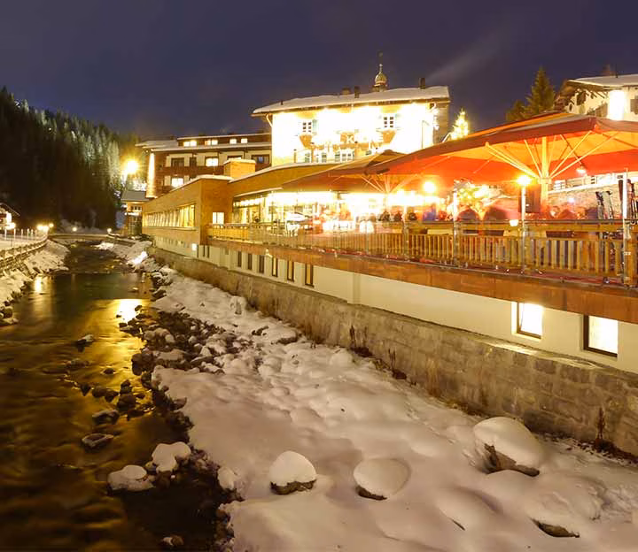Illuminated terrace on the side of a river in winter