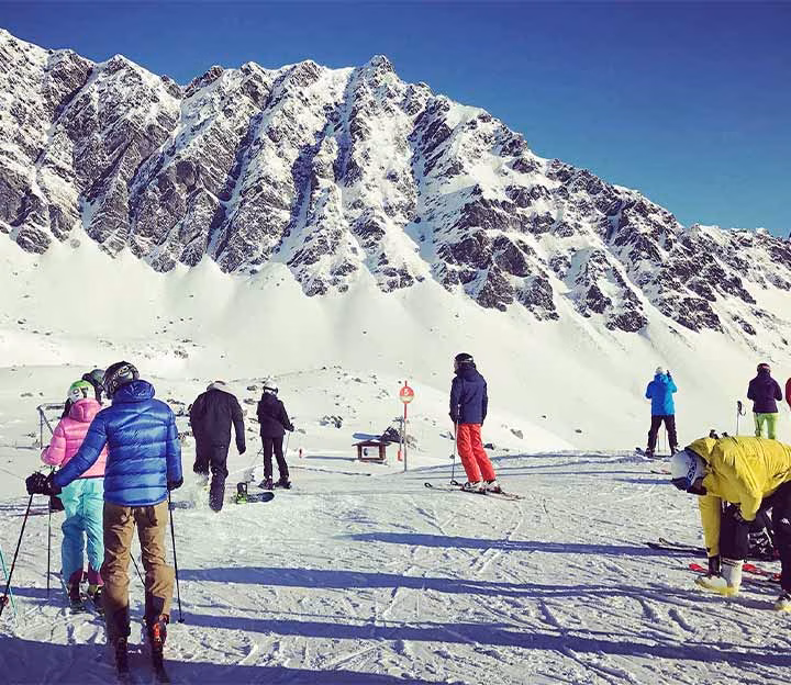 Skiers standing in a group on the slopes