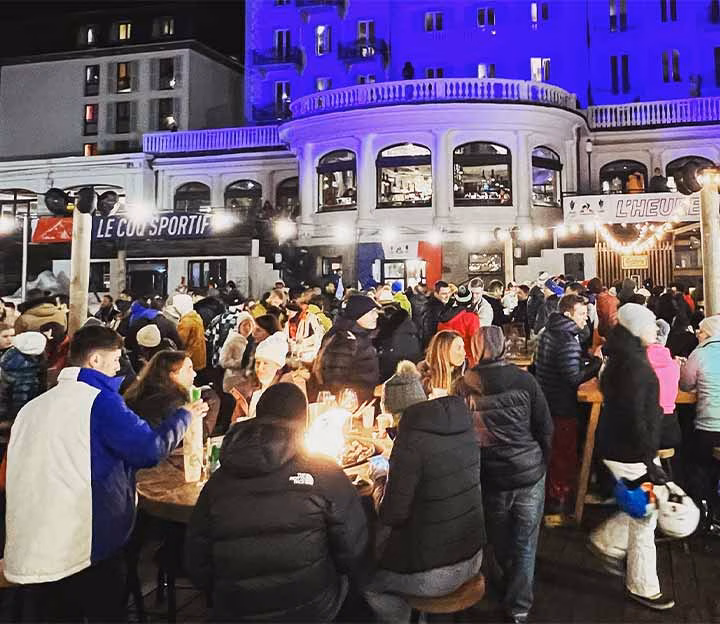 People on an apres ski terrace at night