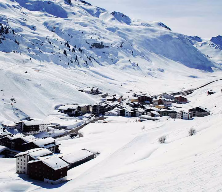 Distant village in a snowy valley in the mountains