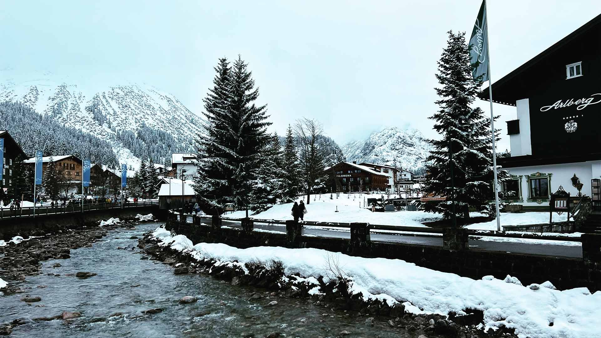 An Alpine river in a cloudy mountain village