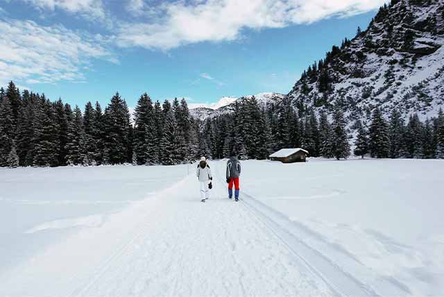 Two people on a snowy path on a winter walk