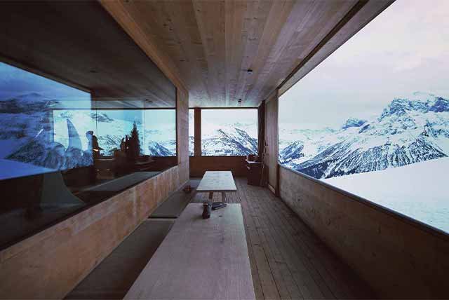 A modern wooden hut in the snowy mountains