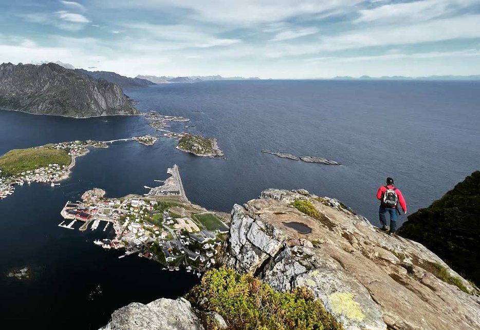 Person hiking on coastal mountains in Lofoten