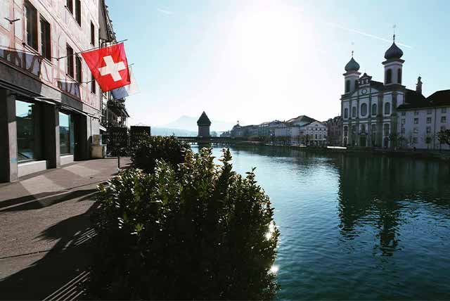 Swiss flag flying on the water front of Lucerne