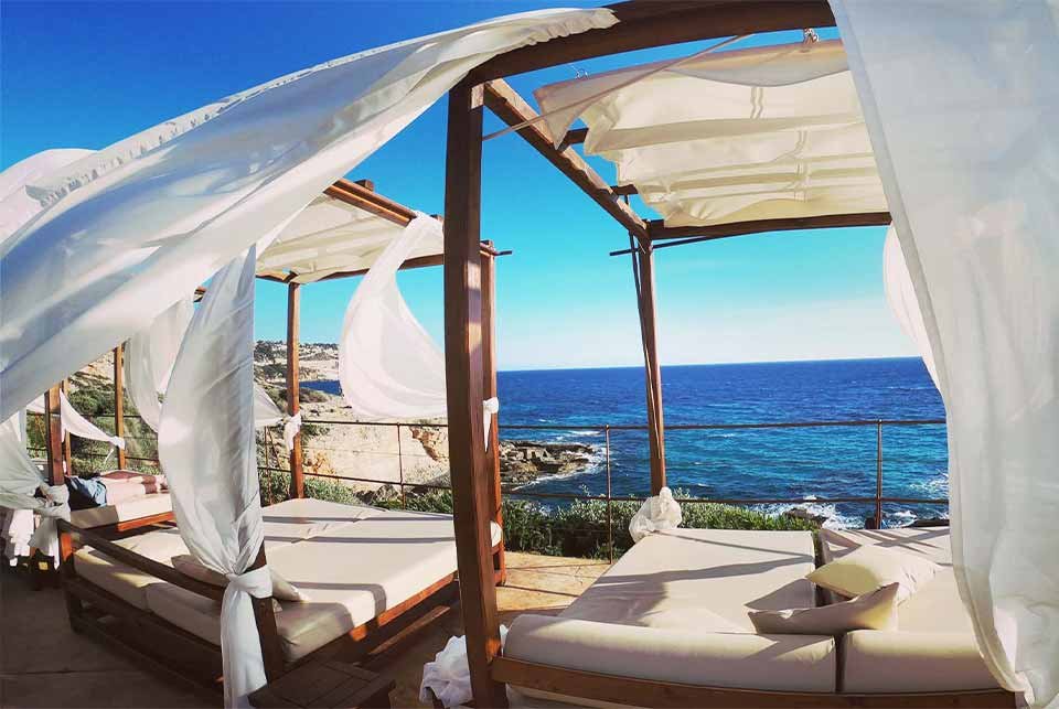 Wind blowing through sun loungers on the coast