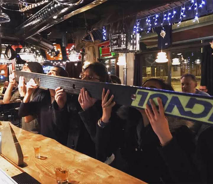 People drinking from a schnapps ski