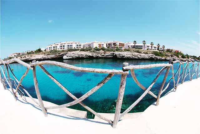 A wooden fence on a waterfront promenade