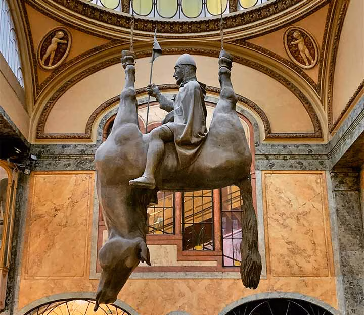 Sculpture of knight sitting on an upside down horse
