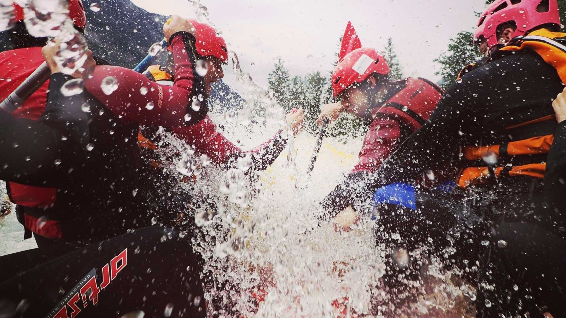 People riding through rapids of a white water raft
