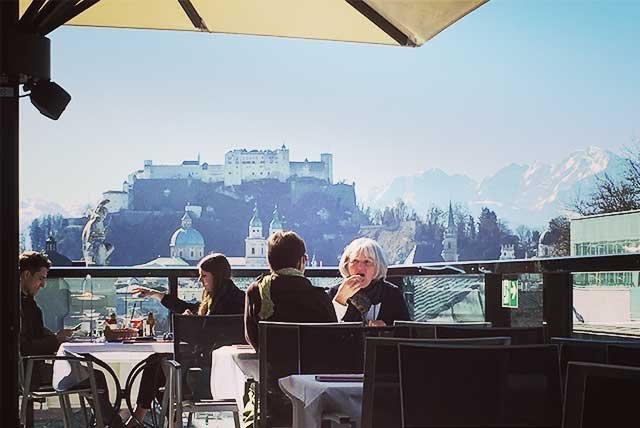 People dining on a rooftop terrace in Salzburg