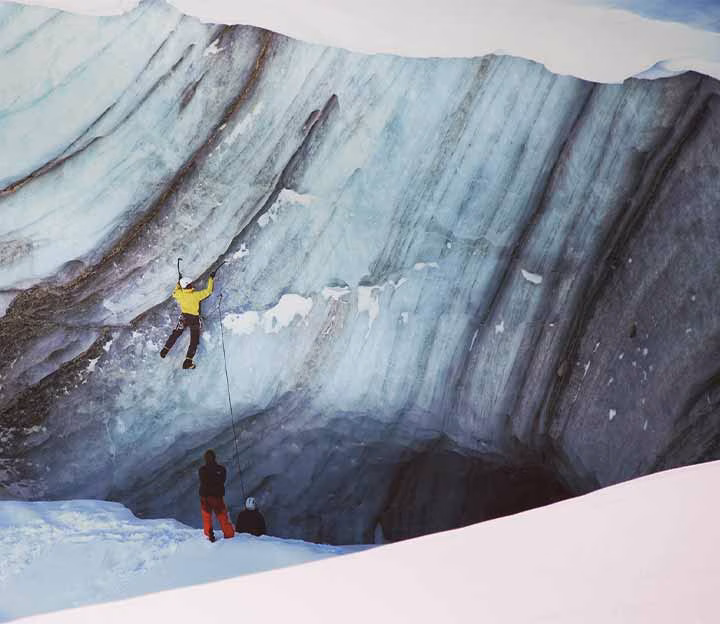 2 people ice climbing on a glacier