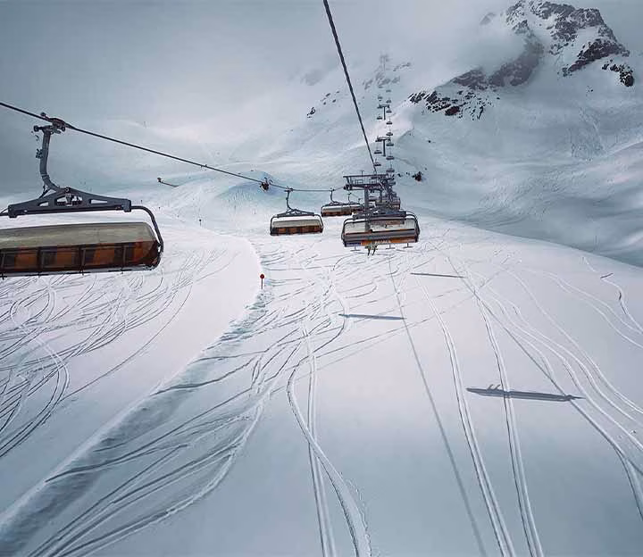 Chairlifts rising into the clouds