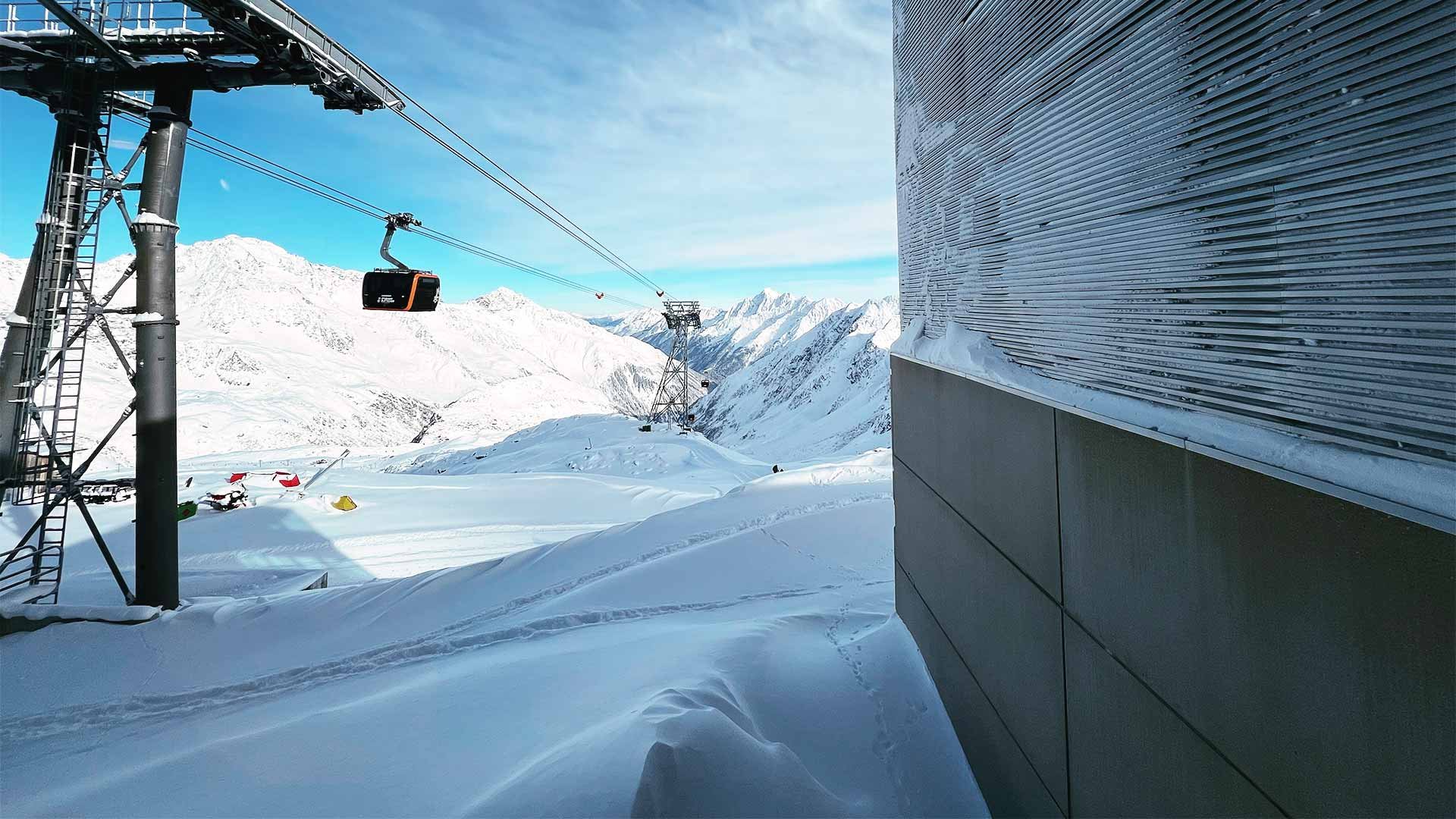 Cable car approaching a snowy mountain station