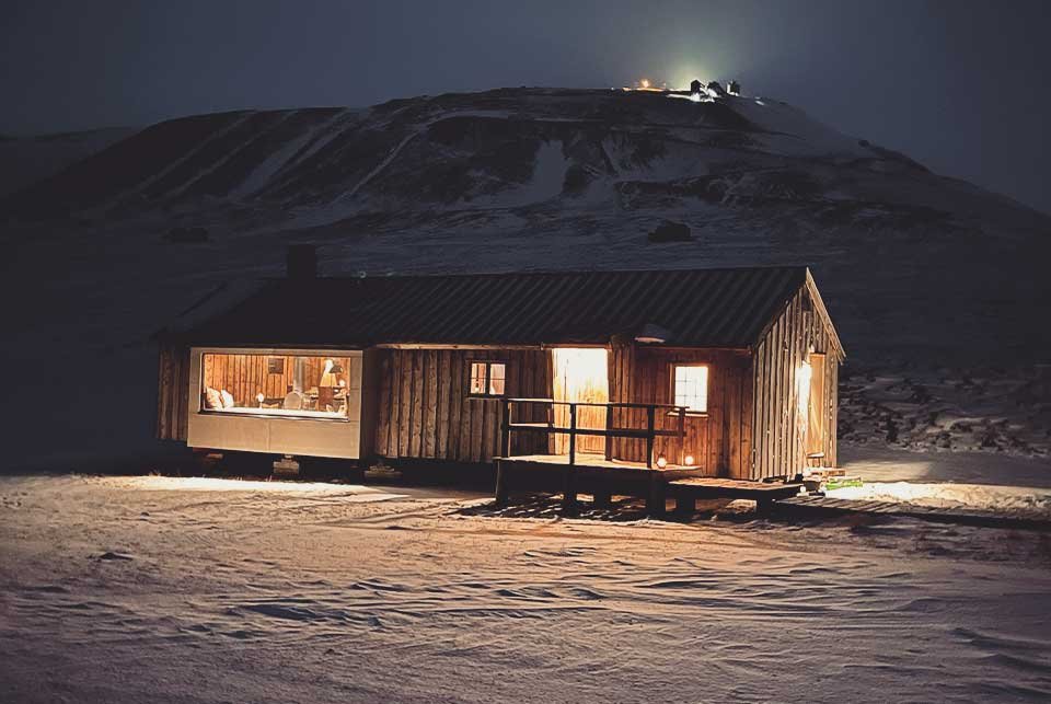 A hut at night in the snow of Svalbard