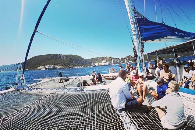 People on the deck of a catamaran
