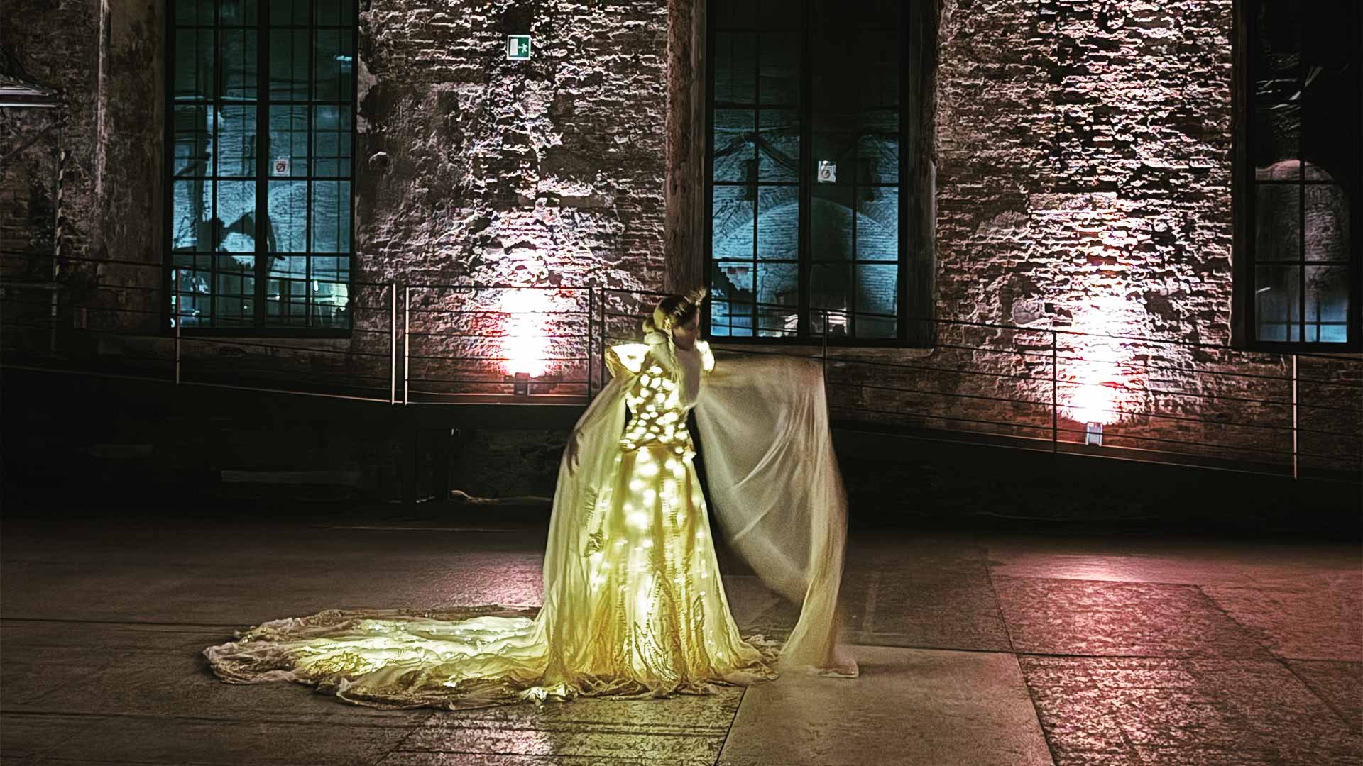 An illuminated artist performing in a venue