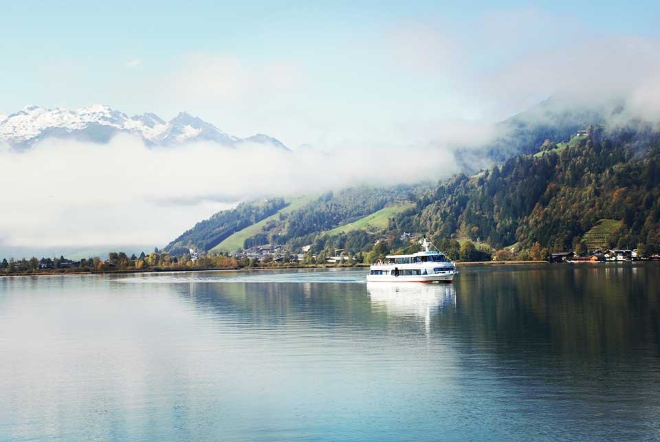 Boat cruising on an Alpine lake