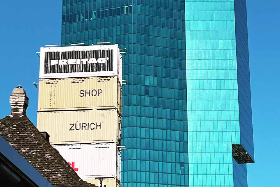 Stack of containers in front of an office building