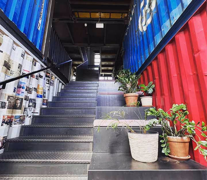 Stairway leading up between shipping containers